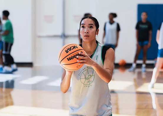 Basketball player holding ball preparing to shoot