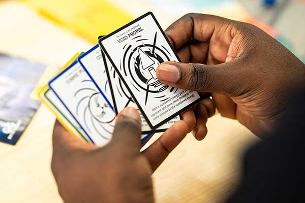 Close-up of God Gauntlet cards from FGCU student-founded board game startup.