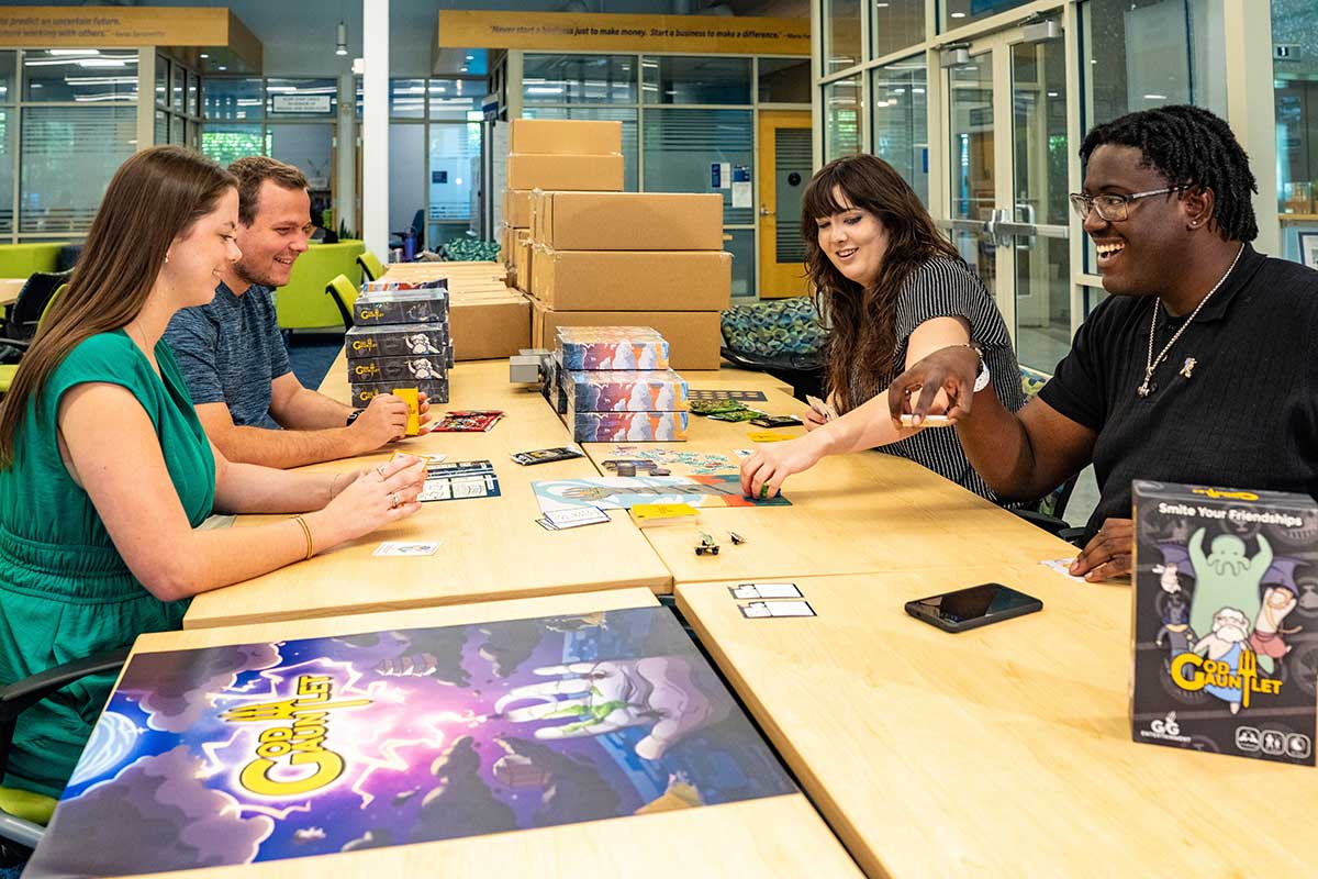 entrepreneurs test God Gauntlet board game through Runway Program startup development.