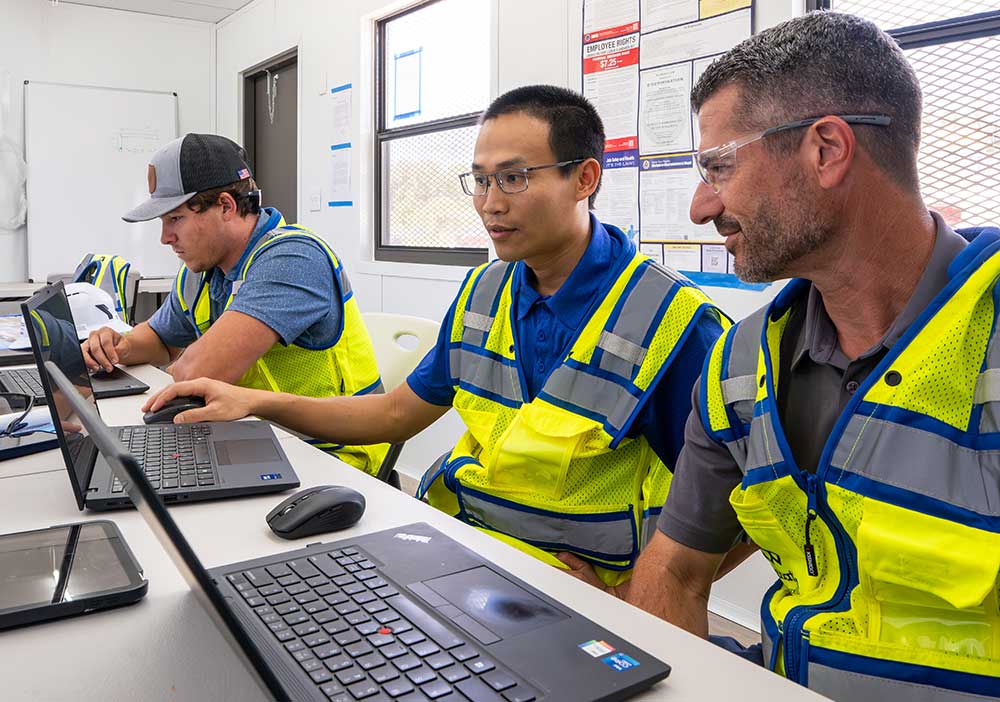Construction team collaborates on project planning in site office