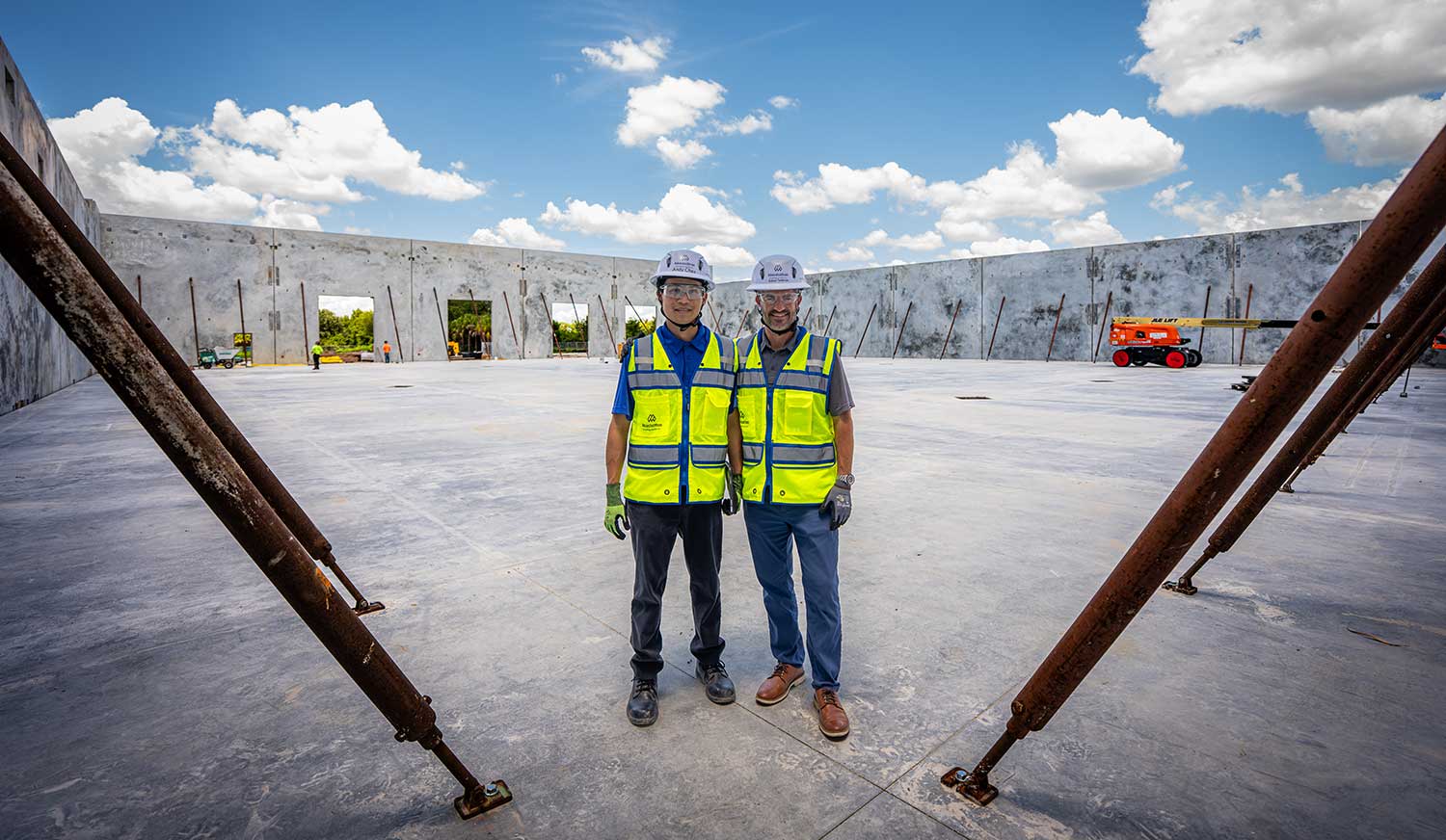 Construction professionals inspect industrial building project