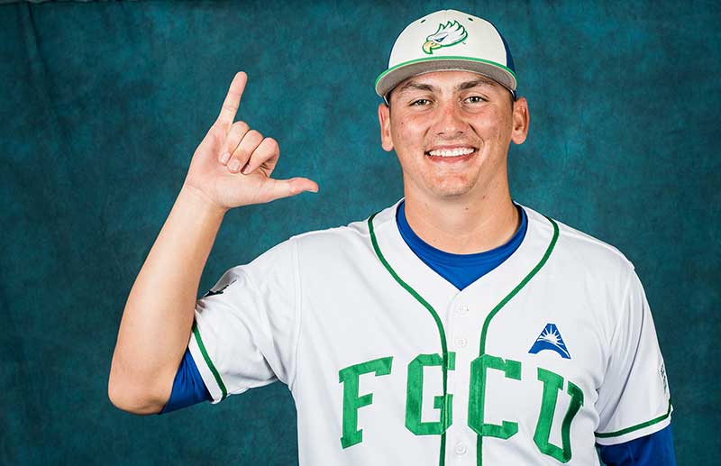 FGCU baseball player poses in team uniform