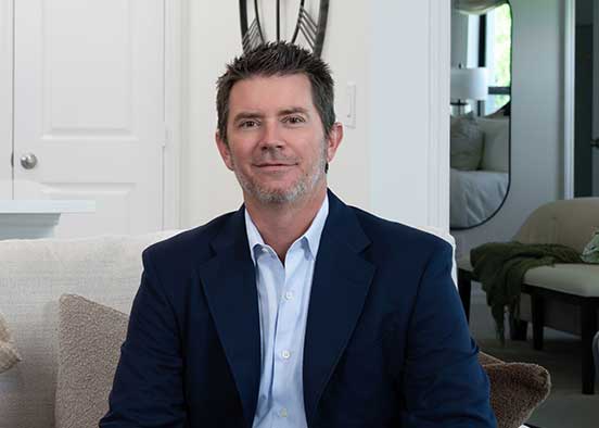 Man in blue suit sitting in a home