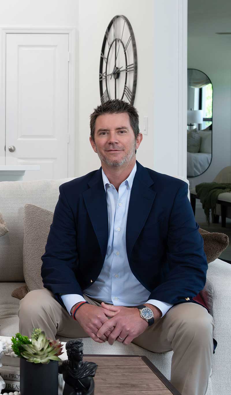 Christopher Alan Homes CEO Ian Schmoyer seated in a home
