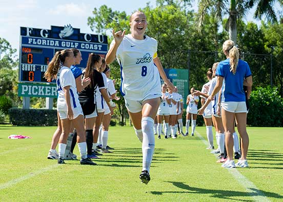 FGCU soccer player runs through pregame introductions