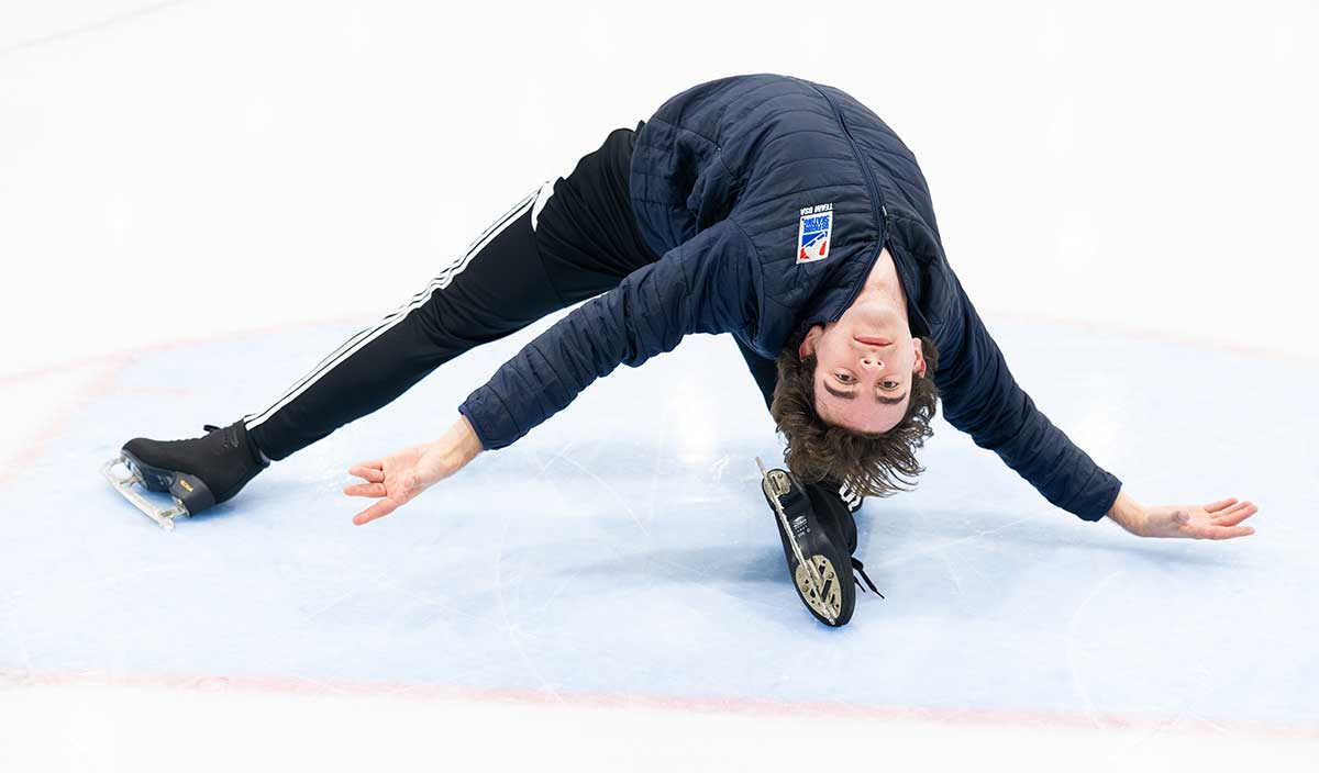 Figure skater performs expressive movement during ice practice