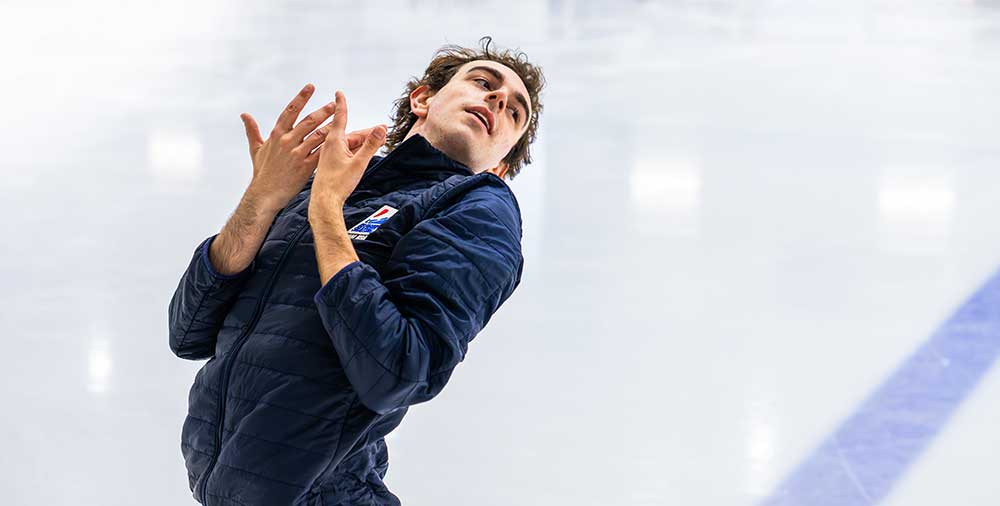 Figure skater performs expressive movement during ice practice