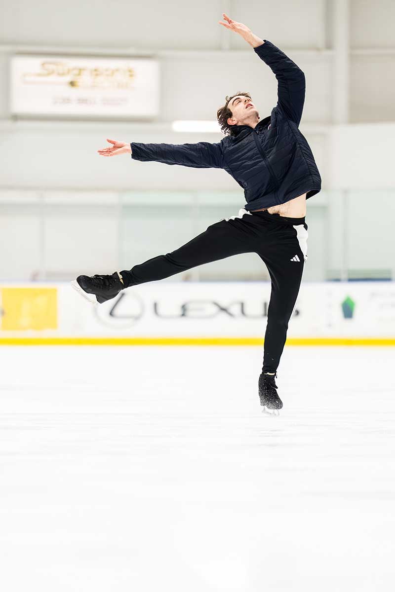 Figure skater performs expressive movement during ice practice