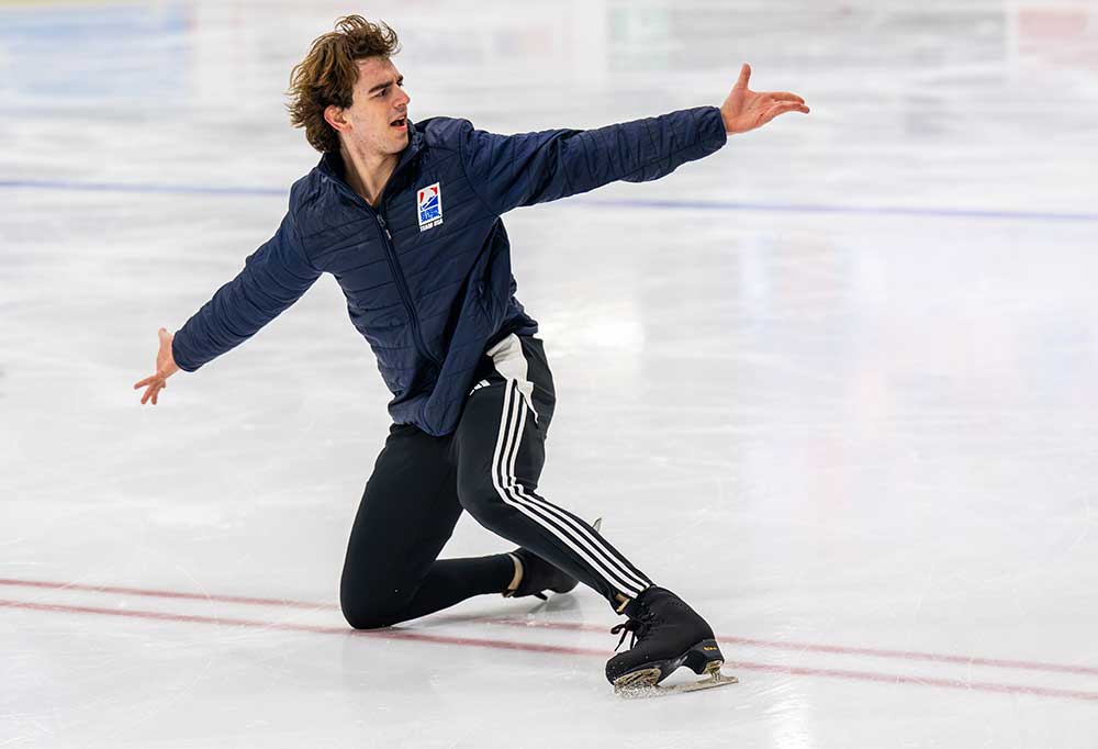 Figure skater glides across rink in choreographic training move