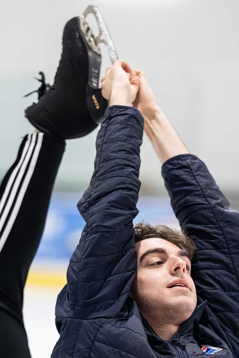 Figure skater performs catch-foot spiral during on-ice training
